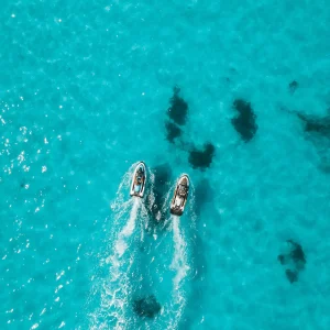 vacancesguadeloupe__aerial-view-of-two-people-riding-jet-skis-2026-03-18-12-15-26-utc