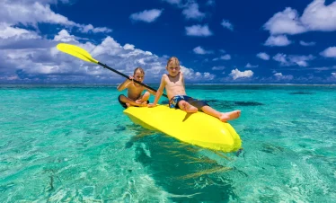 vacancesguadeloupe__two-young-caucasian-boys-kayaking-at-tropical-sea-2026-03-15-23-27-32-utc