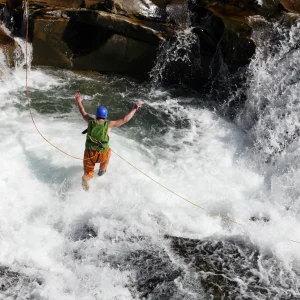 vacancesguadeloupe__young-man-rope-jumping-in-rapid-waters-of-a-river-2026-01-07-05-54-54-utc